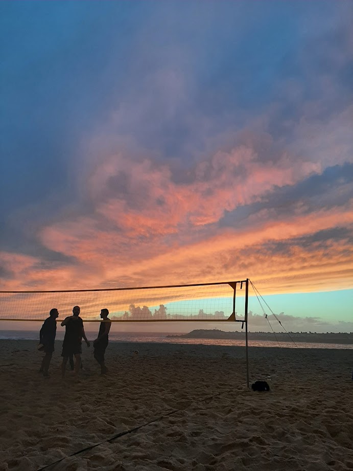 Beach volleyball at sunset